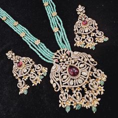 "Handmade Indian Temple Jewelry, best to wear it for traditional ceremonies or Indian wedding. This bridal jewelry has ethnic finish. It has Cubic Zircon stones with ruby and emeralds. It is a Bollywood style one gram jewelry. There are long and short patterns of Indian jewelry in Kundan, Pearls, CZ, American Diamond , ruby, emerald, Polki, kemp to suit every occasion of South Indian and North Indian weddings.  Handmade Indian Jewelry item * Stunning Hand made Gold Plated temple design set. * Necklace Set is a combo of Necklace & Stud Earrings *Gold Color is Matte gold tone which has a antique hue as opposed to bright gold  * Necklace is adjustable with adjustable back chain * Necklace Length: 24\",  * Earring Length: 3\", Earring Width: 1.5 \" * Packed in box , Ideal For GiftingOn Request Traditional Hand Set Bridal Sets With Chandbali Shape, Elegant Hand Set Traditional Wear For Diwali, Traditional Wear With Intricate Design For Reception, Traditional Emerald Kundan Necklace For Formal Occasions, Silver Emerald Necklace With Stone Work For Wedding, Fusion Style Diamond Bridal Necklace With Stone Work, Fusion Style Bridal Diamond Necklace With Stone Work, Elegant Ceremonial Traditional Wear With Stone Work, Emerald Kundan Necklace With Intricate Design For Festive Occasions