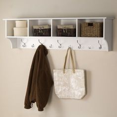 a white coat rack with two coats hanging on it's sides and three baskets in the back