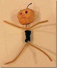 a wooden stick insect with a smiling face on it's back legs