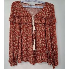 Nwot M Cy Fashions Rust Floral Peasant Tassels Ruffles Womans Top Blouse Flowy Love This Peasant Top! This Is Something We Would Have Worn In The 70's. It's Romantic, Hippie, Folk And Rural All In One. Definately A Great Choice For A Festival Or Concert. Peace! Size: Medium Length Measured From Back Shoulder: Approx 25" In The Assemetrical Style Elastic Sleeve Neck: V Neck With Tassel Tie Pit To Pit Is Approx 21" Shoulders Measures Approx 17" From Seam To Seam Material Rayon Brand New Without Th Fall Peasant Top With Boho Print, Spring Peasant Top With Tassel Ties, Fall Boho Print Peasant Top, Bohemian Long Sleeve Blouse With Fringe, Bohemian Long Sleeve Fringe Blouse, Spring Peasant Blouse With Tassel Ties, Casual Peasant Top With Tassels For Fall, Bohemian Peasant Top With Back Tassel Tie-up, Bohemian Peasant Top With Tassel Ties