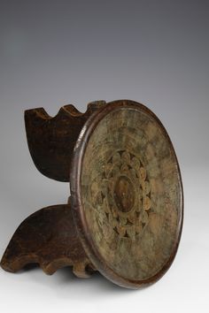 an old wooden object with intricate designs on it