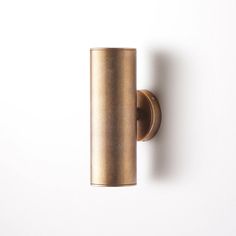 a gold door handle on a white wall