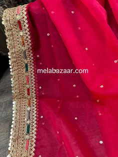 Sheer and lightweight hot pink organza dupatta with mutlicolor embroidery on gold border. Pink Sharara With Mirror Work In Tissue Silk, Pink Tissue Silk Sharara With Mirror Work, Pink Tissue Silk Choli With Mirror Work, Red Raw Silk Dupatta With Gota Work, Pink Organza Choli With Dupatta, Festive Party Choli With Embroidered Border, Festive Gold Sharara With Embroidered Border, Pink Tissue Silk Choli With Gota Work, Red Dupatta With Zari Work In Tissue Silk