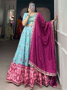 Introducing our stunning "charming sky-blue floral printed silk function wear lehenga choli" set, perfect for all your special occasions. This exquisite ensemble includes a sky-blue lehenga with floral print work and sequin lace border, a matching choli, and a pink maslin silk dupatta with intricate details. Made from high-quality silk material, this set is sure to make you stand out at any event.
This beautiful lehenga choli set is endless. Whether you're attending a wedding, festival, or any o Festive Bollywood Anarkali Set In Light Blue, Anarkali Sets In Turquoise For Navratri, Festive Light Blue Bollywood Anarkali Set, Floral Print Lehenga With Traditional Drape For Eid, Light Blue Anarkali Set With Resham Embroidery For Festivals, Anarkali Light Blue Set For Festivals, Unstitched Floral Print Lehenga For Diwali, Traditional Light Blue Sets With Unstitched Blouse, Semi-stitched Floral Print Lehenga For Eid