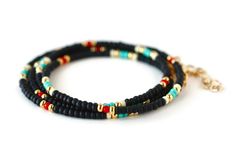 "Black, turquoise, red, white and gold beaded wrap style bracelet is 28\" long and will wrap around on average wrist (6.5-7\") four times. It comes with 1\" chain extender. It could be worn also as a necklace. Details: - Adjustable wrap style bracelet: 28\" long with 1\" chain extender, full length 29\" designed to fit 6.5-7\" wrists, - Listings include one bracelet - Bracelets may vary in exact pattern. Slight variations due to the individuality of each piece - This item should be kept away fro Black Round Beads Jewelry For Beach, Bohemian Black Jewelry With Spacer Beads, Hand Wrapped Black Jewelry For Beach, Hand Wrapped Black Beach Jewelry, Black Bohemian Beaded Bracelets With Spacer Beads, Black Spacer Beads Jewelry For Festivals, Black Spiritual Jewelry For The Beach, Spiritual Black Jewelry For The Beach, Spiritual Black Jewelry For Beach