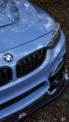 the front end of a blue bmw car