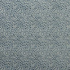 an up close view of the texture of a leather material with small circles on it