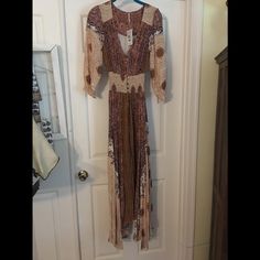 Light Weight Flowing Dress Brown V-neck Boho Dress For Fall, Flowy Brown V-neck Midi Dress, Brown Long Sleeve Boho Dress For The Beach, Long Sleeve Brown Boho Dress For The Beach, Long Sleeve Brown Bohemian Boho Dress, Brown Boho Long Sleeve Dress For Spring, Brown Long Sleeve Beach Dress, Brown Long Sleeve Boho Dress For Spring, Brown Long Sleeve Boho Dress