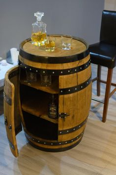 a wooden barrel table sitting on top of a hard wood floor