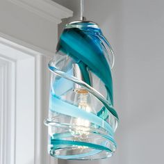 a blue glass light fixture hanging from a ceiling