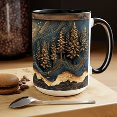 a coffee mug sitting on top of a wooden table next to a spoon and fork