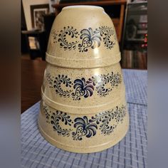 a stack of three bowls sitting on top of a blue and white checkered table cloth