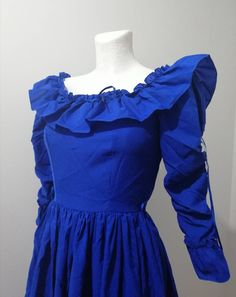 Electric blue dress. Vintage from 80s. Dress with frills, bow, long sleeves, zip fastener. The skirt is flared. Really beautiful dress. Garment measurements, flat, doubled: Bust: 84 cm / 33,07 inch Waist: 64 cm / 24.80  inch Hips: free Full Length: 133 cm / 52,36 inch Blue Long Sleeve Victorian Dress For Wedding, Blue Long Sleeve Victorian Wedding Dress, Blue Victorian Dress With Ruffles For Fancy Dress, Blue Victorian Dress With Ruffles For Wedding, Blue Victorian Dress With Ruffles For Costume, Regency Style Ruffled Dress For Costume Party, Elegant Blue Vintage Dress With Ruffles, Blue Vintage Victorian Dress For Party, Vintage Blue Victorian Dress For Party