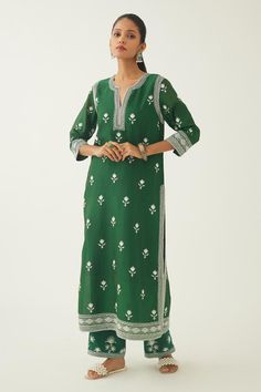 Green straight kurta with thread embroidery in floral pattern on neckline and sleeve hem. Paired with straight pant and dupatta with floral hand block printed border on the edges.
Components: 3
Pattern: Embroidery, Hand Block Printed
Type Of Work: Thread, floral
Neckline: Notched
Sleeve Type: Three quarter
Fabric: Silk Chanderi
Color: Green
Other Details: 
Lined kurta
Embroidery on pant hem
Elasticated waist at the back
Side pockets
Thread tassel bordered dupatta
Closure: Pant: Drawstring
Occasi Kurta Embroidery, Kurta Set For Women, Types Of Work, Embroidery Hand, Straight Kurta, Pattern Embroidery, Thread Embroidery, Fabric Silk, Kurta Set