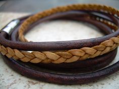 A rich and and tasteful double wrap leather bracelet in perfect Fall colors... This bracelet style features 3 strands of Fine Premium Quality - 5mm flat braided and 3mm round leather cords. A secure stainless steel magnetic closure clasp serves as a focal point, ( 20 mm or approx 3/4 inch in length) for easy on and off. All dyes used in our leather are certified 100% Lead-Free and meet all requirements of the German Goods Ordinance, REACH (European Union), RoSH (U.K.), and CPSIA (U.S.) which req Brown Double Band Bracelet With Leather Strap, Brown Double Band Leather Bracelets, Brown Double Band Leather Strap Bracelets, Brown Leather Strap Double Band Bracelets, Adjustable Double Band Brown Wrap Bracelet, Natural Braids, Men's Bracelets, Bracelet Mens, Bracelet Style