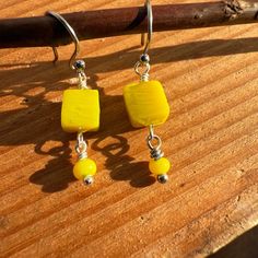 Dainty And Bright Yellow Glass Square Shaped Bead With Stainless Steel Silver Color Ear Wire. Made For Sensitive Ears. Measurements: Over All Length With Ear Wire: 1.25 Inches Ear Wire: .5 Inch Drop: .75 Inch These Are Made To Order And Color, Size, Finishes And Shapes May Vary Slightly From Photos. Nickel-free Yellow Beaded Earrings As Gift, Nickel Free Yellow Beaded Earrings For Gift, Nickel-free Yellow Beaded Earrings For Gifts, Adjustable Yellow Beaded Earrings With Ear Wire, Yellow Dangle Beaded Earrings For Gifts, Adjustable Yellow Beaded Earrings, Yellow Beaded Earrings For Gift, Yellow Beaded Drop Earrings As Gift, Yellow Drop Beaded Earrings As Gift