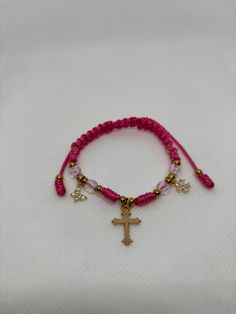 a bracelet with a cross and beads on it