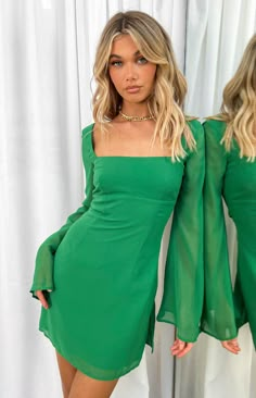 * Green Long Sleeved Mini Dress () 
 * We are OBSESSED with this pop of colour! Add a pair of your fav mules () and you have the perfect dinner date fit! 
 * 
 
 * Mini Length 
 * Mesh like non-stretch material 
 * Square neckline 
 * Body lined 
 * Flared unlined sleeves 
 * Criss Cross tie up at back 
 * Slight flare from the hips down 
 * Mid weight material