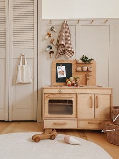 a wooden cabinet sitting on top of a hard wood floor next to a white rug