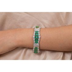 This is part of Chairish’s Fine Jewelry assortment.  This Art Deco Emerald Diamond Wedding Bracelet in 18K gold showcases 40 endlessly sparkling natural emerald, weighing 23.74 carat and diamonds weighing 7.09 carat. It measures 7.5 inches long in length.  Emerald enhances the intellectual capacity of the person. Designed with perfect oval cut emerald set horizontally in between the diamonds with diamond charm in center to make you stand out on any occasion or event. The elegant style complements the attire beautifully and this is a perfect Unique Gift, Bridal Shower Gift, Secret Santa Gift, Gift For Sister, Mother Daughter Gift, Bride To Be Gift, Bridesmaid Gift, Thanksgiving Gift, Anniversary Present, Christmas Gift or any Holiday Gift for Mother, Sister, Daughter, Grandma, Fiancé, Girlf Emerald Tennis Bracelet With 17 Jewels For Wedding, Green Gemstone Diamond Bracelet For Formal Occasions, Formal Green Diamond Bracelet With Gemstone, Formal Green Diamond Jubilee Bracelet, Fine Jewelry Emerald Diamond Bracelet For Wedding, Emerald Diamond Bracelet For Wedding, Elegant Emerald Diamond Bracelet For Wedding, Emerald Jubilee Bracelet For Wedding, Wedding Emerald Diamond Bracelet