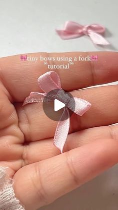 someone is holding a tiny pink bow in their hand with the text tiny bows using a fork