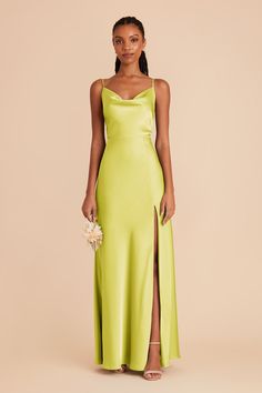 a woman in a lime green dress with a slited skirt and high slits