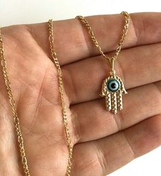 "18K GOLD FILLED HAMSA WITH EVIL EYE NECKLACE 18\" LONG...FOR GOOD LUCK ,PROSPERITY AND PROTECTION. PENDANT : 21x13mm 18K GOLD FILLED CADENA DE MANO DE FATIMA Y OJO DE LA BUENA SUERTE 18\" LARGO ..PARA PROSPERIDAD, BUENA SUERTE Y PROTECCION. DIJE:21x13mm" Handmade 14k Gold Jewelry For Good Luck, Dainty Evil Eye Jewelry For Good Luck, Gold Dangle Jewelry With Evil Eye, 14k Gold Evil Eye Charm Necklace, Gold Evil Eye Dainty Jewelry, Gold Dainty Jewelry With Evil Eye, 14k Gold Filled Evil Eye Jewelry, Dainty Gold Evil Eye Jewelry, Protection Pendant