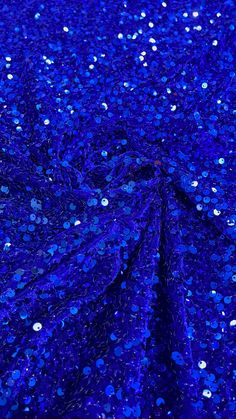 stretch velvet with luxury sequins all over 5mm shining sequins 2-way stretch Width: Stretch Velvet 58"/60" 2 - Way Stretch Content: 85% Polyester Sequin Collection is a stretch velvet fabric that has sequins embroidered throughout the whole fabric. This fabric is ideal for decorative and apparel purposes. The width of the velvet fabric is 60" and the sequins are embroidered at 58"/ 60". Item is sold by the yard. If more than one yard is purchased, item will come in one piece. Uses: Dress, Gowns Blue Sequin Fabric For Party Season Night Out, Blue Sequin Fabric For Party Season And Night Out, Glamorous Blue Sequin Fabric For Party Season, Blue Sequin Fabric For Party Season, Blue Sequin Fabric For Festive Party Occasions, Blue Festive Sequin Fabric For Evening, Blue Contrast Sequin Fabric For Festive Occasions, Blue Sequin Fabric For Festive Party, Glamorous Blue Sequin Fabric For Festive Occasions