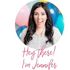 a woman is smiling and holding balloons in front of her face with the words hey there i'm jennyie on it