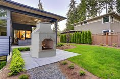 an outdoor fireplace in the middle of a yard