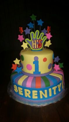 a brightly colored birthday cake with stars on top