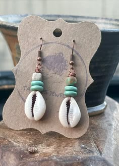 Cowrie shell earrings. Rustic copper earrings. Ethnic jewelry. Boho jewelry. Artisan earrings. The ear wires are pure copper wire. These earrings are very lightweight and comfortable. ● Materials: Copper, African turquoise beads, Cowrie shells. ● Measures: Total length including ear wires - about 2 inches Dangle Cowrie Shell Earrings For Beach, Bohemian Adjustable Cowrie Shell Earrings, Beach-style Cowrie Shell Earrings, Beaded Cowrie Shell-shaped Jewelry, Casual Cowrie Shell-shaped Jewelry, Cowrie Shell Earrings, Cowrie Shell Jewelry, African Inspired Jewelry, Tiffany And Co Jewelry