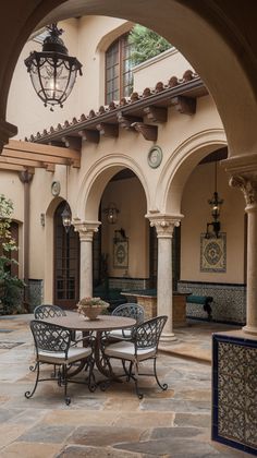 an outdoor dining area with tables and chairs in the center, surrounded by archways