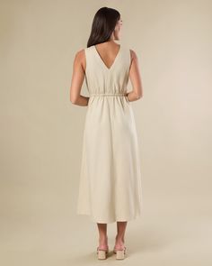 Lightweight and floaty in our summer-weight linen blend, this button-down midi dress is designed with a v-neck bodice featuring pintucked pleats and a cinched-in stretch waist. Pintuck pleat detail on bodice Encased elastic at waist Functional buttons at bodice only V-neckline Midi length Flowy skirt 60% Tencel 20% Linen 20% Cotton Machine wash with like colors. Do not bleach. Hang to dry. Iron warm. Summer Midi V-neck Dress With Tie Waist, Spring V-neck Midi Dress With Pleated Waist, Solid V-neck Midi Dress With Smocked Back, Elegant V-neck Midi Dress With Elastic Waistband, V-neck Midi Dress With Gathered Waist For Day Out, Casual Spring Linen Dress With Smocked Back, Spring Unlined Linen Midi Dress, Spring Midi-length Unlined Linen Dress, Summer Midi Dress With V-neck And Smocked Back