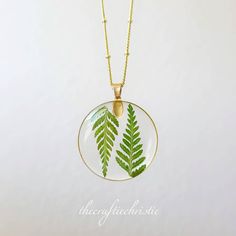 This magical necklace is crafted by systematically placing a delicate Fern in resin pendants. Choose your favorite necklace to go along with a beautiful gold chain. The Pendant and Chain are Lead free and Nickel Free! It is important to preserve the jewelry in the box provided safely after use. Enjoy this necklace with a chain length of your choice. You can see more of my Handmade Items here: https://www.etsy.com/shop/Thecraftiechristie Handmade Nature-inspired Necklaces With Round Pendant, Handmade Nature-inspired Round Pendant Necklaces, Nature-inspired Round Necklaces For Jewelry Making, Botanical Resin Jewelry With Natural Inclusions, Nature-inspired Birth Flower Resin Jewelry, Nature-inspired Resin Birth Flower Jewelry, Nature-inspired Necklaces With Pressed Flowers, Nature-inspired Leaf-shaped Jewelry With Pressed Flowers, Nature-inspired Round Resin Necklace