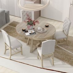 a round table with chairs around it in the middle of a living room and dining area