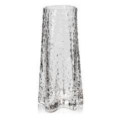 a tall glass vase sitting on top of a white table