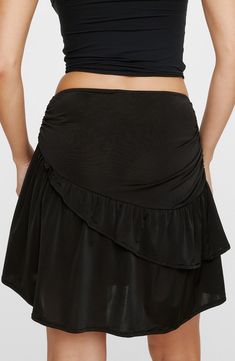 Enjoy the comfortable stretch of this weekend-ready skirt accented with side ruching and an asymmetric ruffle. Exclusive retailer Pull-on style 96% polyester, 4% elastane Machine wash, line dry Made in Turkey Solid Color Mini Swim Skirt With Ruffles, Black Fitted Skort With Asymmetrical Hem, Fitted Black Skort With Asymmetrical Hem, Stretch Ruffled Skirted Skort, Black Asymmetrical Fitted Skort, Black Fitted Asymmetrical Skort, Fitted Asymmetrical Bottoms With Ruffled Skirt, Stretch Mini Swim Skirt With Ruffles, Fitted Ruffled Swim Skirt