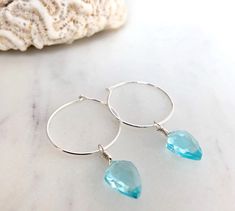 Dainty little aquamarine faceted crystal gemstone hoop earrings in 20mm sterling silver or 14k gold filled hoops. Option for gold plated and silver plated are less expensive. Please see drop down. Perfect for March birthdays! 💙Aquamarine, a stone of serenity, calms and soothes with it's lovely blue/green color and evokes the calm of the water with it's given name, which is interpreted at 'water of the sea' derived from Latin. A stone that celebrates the sea goddess of ancient times, it was carr Blue Hypoallergenic Small Hoop Jewelry, Hypoallergenic Blue Small Hoop Jewelry, Blue Teardrop Gemstone Hoop Earrings, Blue Sterling Silver Hoop Jewelry, Blue Hoop Sterling Silver Jewelry, Blue Hoop Earrings In Sterling Silver, Blue Sterling Silver Small Hoop Jewelry, Small Blue Sterling Silver Hoop Earrings, Blue Sterling Silver Hoop Earrings Nickel-free