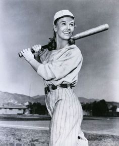 an old black and white photo of a baseball player holding a bat