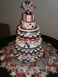 a multi tiered cake with cupcakes and stars on it