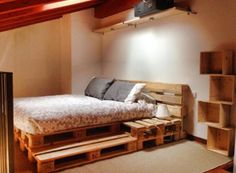 a bed made out of wooden pallets in a room