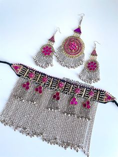 Afghan vintage Pink 3 piece kuchi jewellery set,kuchi necklace,  Afghan jewellery, Afghan Fashion,  Set includes:  -1 pair of oversized earrings  -1 necklace  -1 tikka  Message for any inquiries Our Aim as a business is to connect Afghan women with their roots and to make anyone that purchases our jewellery feel powerful and beautiful as each and everyone of our items is handcrafted with care and love. Vintage Pink Jewelry For Festivals, Pink Latkan Festival Jewelry, Pink Festival Jewelry With Latkans, Pink Bohemian Jewelry For Festive Occasions, Handmade Pink Jewelry Sets For Festivals, Traditional Handmade Pink Jewelry Sets, Bohemian Tilla Jewelry Sets For Festivals, Bohemian Metal Jewelry Sets For Festivals, Pink Bohemian Jewelry For Festivals