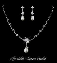 a necklace and earring set with pearls on the side, in white gold plated