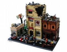 a lego model of a building with people standing outside and on the street in front of it