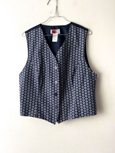 "Vintage Women's summer vest Blue white Patterned viscose Vest Button Up Waistcoat Hippie Festival Vest Size Medium Retro vest 90s lady vest Label size: D/NL 38; B/F 40; GB 12 Estimated size: M Measurements (lying flat): Length: 19.5\"/ 49.5 cm Pit to pit: 19.5\"/ 49.5 cm Waist: 18.5\"/ 47 cm Please check measurements to insure a proper fit. Remember to allow yourself some extra room for movement. You can compare these with something from your closet that fits you well. This vest will come to you freshly laundered and ready to wear. Please convo me if you need additional measurements. Condition: great Vintage Condition SHIPPING * I ship worldwide via Priority mail (Latvijas Pasts) from Latvia (EU). * I ship from Europe, so please allow 2 to 4 weeks for the package to arrive if you live ove Blue Button-up Vest With Buttons, Classic Summer Vest With Buttons, Blue Button-up Vest With Button Closure, Blue Vest With Button Closure For Spring, Blue Button-up Vest For Spring, Retro Fitted Vest For Summer, Retro Fitted Summer Vest, Fitted Summer Vest With Buttons, Classic Button-up Summer Vest