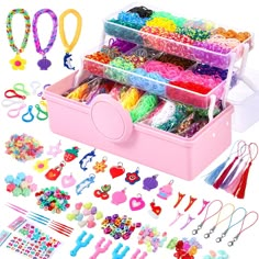 a pink box filled with lots of different types of beads and bracelets on display