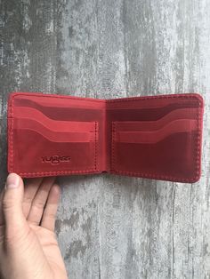 100 % full-grain handmade leather wallet. Slim and small red bifold wallet for men. Precisely made from high quality cow leather. Lasts for years, therefore is a perfect gift. The wallet is engraved with an ancient stylized grass-snake/sun sign. Wallet is made from full grain cow leather. Crazy horse is a specially processed leather type that gives it an antique appearance. This type of leather is long lasting, very durable and any scratches or rubs turn it to a different shade, bend line also f Red Leather Everyday Card Holder, Red Leather Card Holder For Daily Use, Red Leather Trifold Wallet For Everyday, Red Leather Wallet With Card Slots, Red Leather Trifold Rectangular Wallet, Red Leather Trifold Wallet For Daily Use, Red Leather Card Holder With Coin Pocket, Red Leather Card Holder With Interior Slots, Red Bifold Card Holder