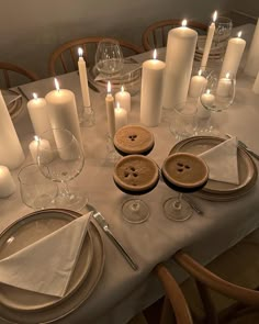 the table is set with candles and plates