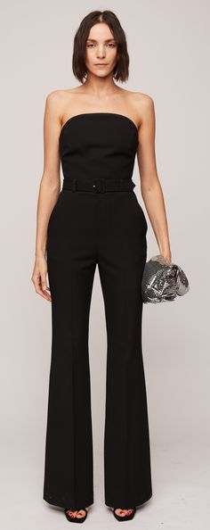 Crafted from our classic suiting material in a timeless black hue, the Kate Jumpsuit boasts a softly sculpted silhouette. It highlights flare legs and a strapless curved neckline with internal bone corsetry and a hook-and-eye panel for added structure and support along the bodice. Completing the ensemble are a belted waist and functional pockets for added convenience. Structured Fitted Pantsuit For Party, Elegant Structured Pantsuit For Party, Chic Structured Party Suits, Sleek Fitted Pantsuit With Structured Boning, Elegant Fitted Pants For Gala, Evening Tailored Pantsuit With Structured Boning, Sleek Structured Evening Pantsuit, Fitted Pantsuit With Structured Boning, Luxury Tailored Evening Pantsuit